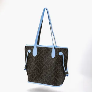 Front view of a brown patterned tote bag featuring light blue straps and trim accents.