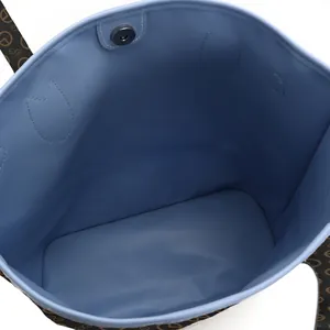Detailed interior view of light blue tote bag showing spacious compartment and magnetic snap