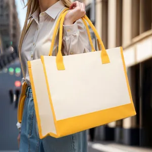 Fashionable large capacity canvas tote bag with yellow trim shown on shoulder