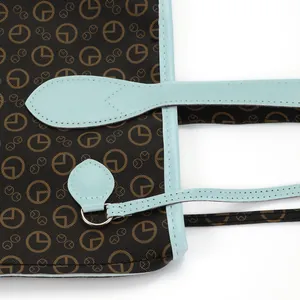 Detail view of printed tote bag with light blue leather contrast trim and stitching