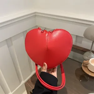 Stylish red heart-shaped shoulder bag with smooth finish for women, versatile spring fashion