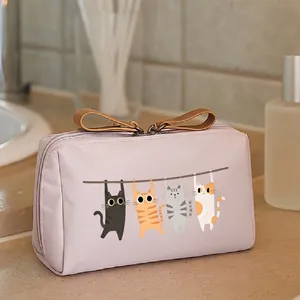 Close-up of pink toiletry bag with cute cat illustrations in a bathroom setting