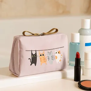 Detailed view of cute cat illustration on pink waterproof portable cosmetic bag