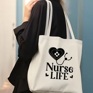 Detalle del bolso de lona blanca con estampado negro Nurse Life llevado por un modelo