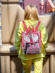 Detail view of a clear PVC backpack with stylish pink trim and FACE embroidered pouch