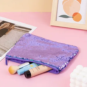 Detail view of a purple mermaid sequin makeup pouch with various cosmetic accessories
