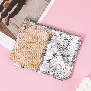 Close-up of a glamorous two-tone mermaid sequin pouch with a smooth silver zipper.