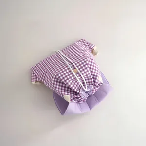 Detailed view of a purple and white gingham drawstring cotton backpack storage bag
