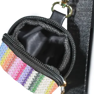 Close-up of a colorful woven mini pouch with black zipper and strap detail.