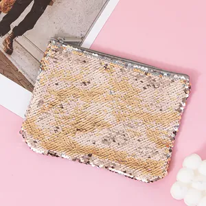Close-up of sparkling rose gold reversible sequin pouch on a soft pink background