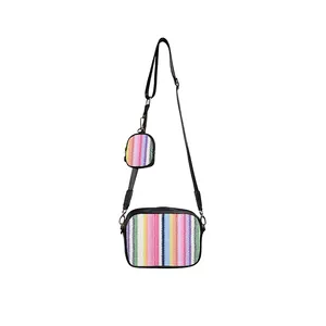 Woven crossbody bag detail showing colorful rainbow stripes and mini coin purse