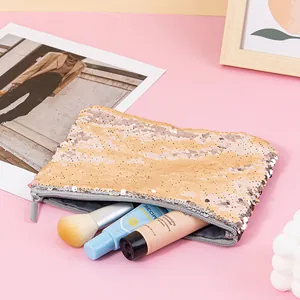 Detailed macro shot of portable mermaid reversible sequin pouch with beauty items