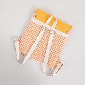 Back view of a yellow checkered cotton drawstring backpack with adjustable straps