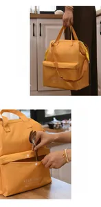 Close-up detail of a yellow insulated lunch bag showing the front storage pocket and utensils