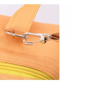 Detailed view of the durable metal shoulder strap clip on an orange insulated lunch bag