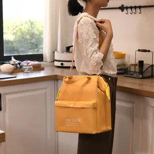 Large capacity yellow insulated lunch bag with adjustable shoulder strap and handle
