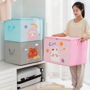 Cute cartoon non-woven storage bag for clothes and quilts shown in a home setting