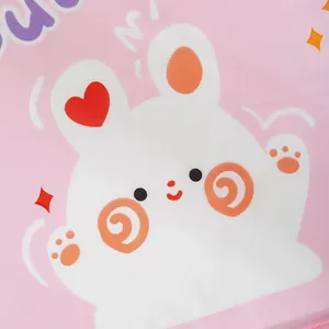 Macro view of cute white rabbit pattern on pink waterproof fabric storage organizer