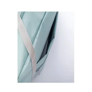 Close-up detail of side zipper pocket and fabric texture on a light blue travel storage bag