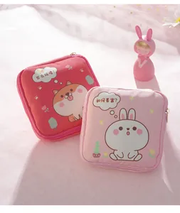 Detail showing two cute cartoon sanitary napkin storage pouches with rabbit and dog prints