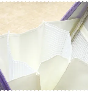 Detailed macro view of internal mesh compartments and purple zipper of large stationery bag