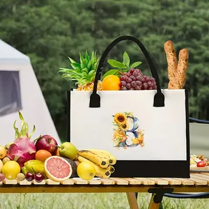 Floral letter B print canvas tote bag shown in an outdoor picnic setting