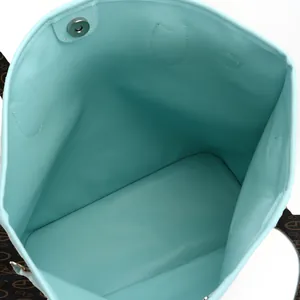Interior view of the turquoise tote bag showing spacious capacity and magnetic snap closure