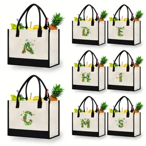 Detailed view of canvas tote bags with various floral letter prints and black trim.
