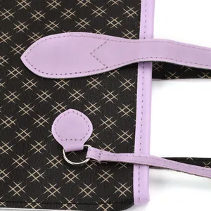 Macro view of purple faux leather handle stitching and tan hashtag print on dark fabric