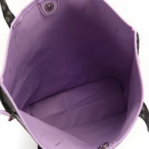 Detail view showing the spacious purple interior and magnetic snap of this printed tote bag.
