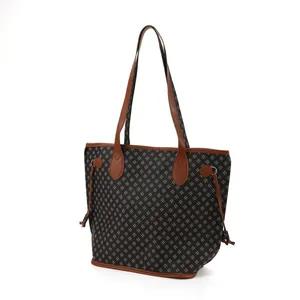 Detailed view of women's printed tote bag with brown leather trim and large capacity