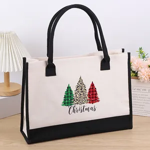 Canvas tote bag with Christmas tree print and black handle detail in a home setting
