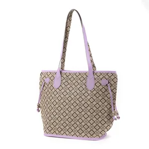 Detail view of the women's printed tote bag with purple straps and clover pattern