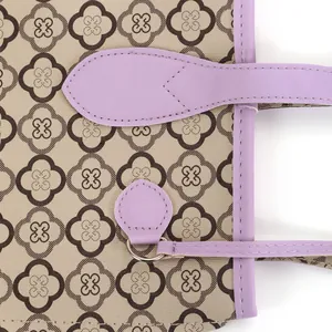 Detailed close-up showing the floral pattern and purple leather trim of a stylish tote bag