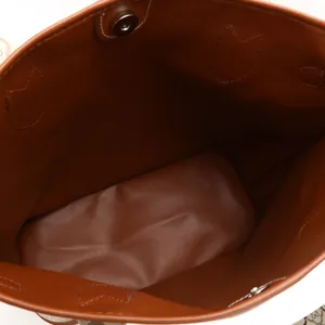 Close-up detail of a large capacity women's tote bag showing spacious brown interior