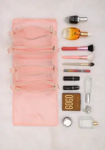 Detail view showing pink detachable four-in-one mesh travel cosmetic bag with makeup items