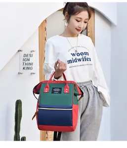 Detail shot of a multi-colored waterproof diaper backpack held by an Asian model