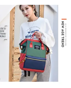 Model carrying a large capacity multi-color waterproof Oxford backpack for daily commute