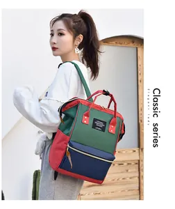 Multi-colored waterproof oxford mommy backpack shown on an Asian woman's shoulder