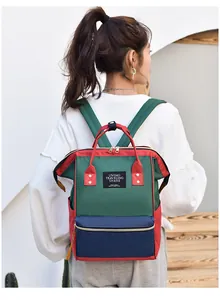 Detailed back view of a multi-color waterproof large capacity mummy backpack worn by model