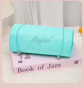 Detail view of mint green 4-in-1 foldable travel makeup and toiletry organizer bag.