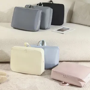 Set of expandable travel compression bags for clothing storage in various colors