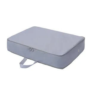 Grey expandable compression storage bag for clothes and down jackets on white background