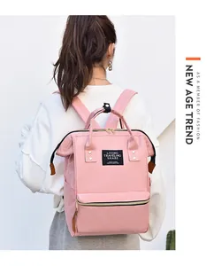 Lifestyle view of a waterproof pink mommy backpack worn by a model in a casual setting