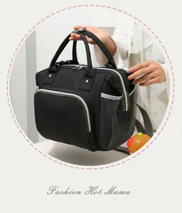 Close-up of a black insulated mummy bag with mesh side pockets and dual zippers.