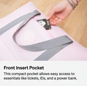 Close-up detail of the convenient front zipper pocket on this pink waterproof travel bag