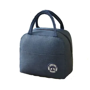 Navy blue insulated lunch bag with cute panda patch and sturdy woven handles for work