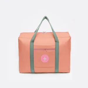 Large capacity waterproof travel duffel bag with peach pink fabric and green straps