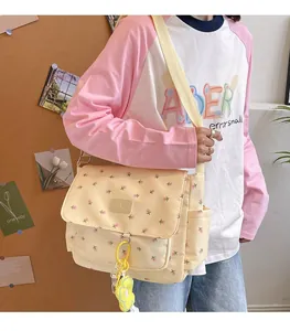 Cute yellow floral canvas tote bag shown being worn as a stylish student shoulder bag.