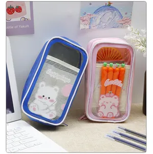 Close-up of cute transparent pencil pouches with cartoon bear designs and carrot pens